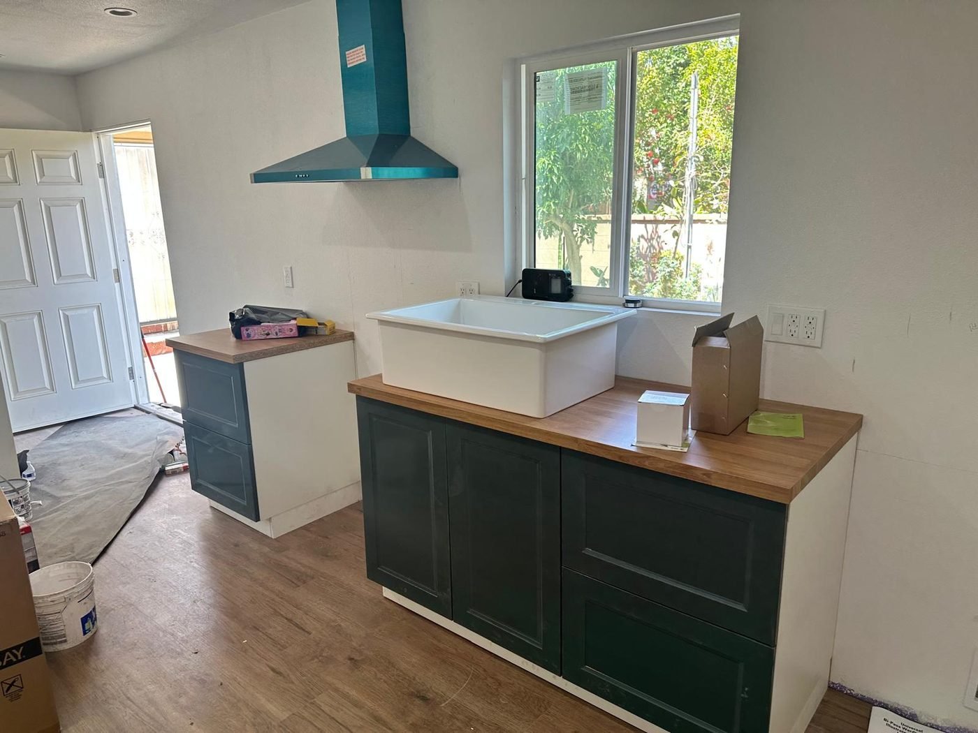 Kitchen remodel in progress with new cabinets and farmhouse sink